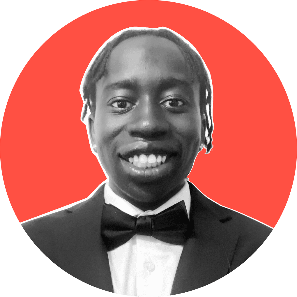 A young black man smiling at the camera