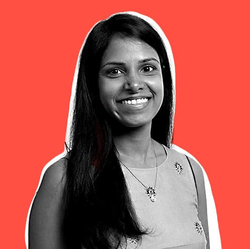 Sireesha is smiling and looking confidently at the camera.