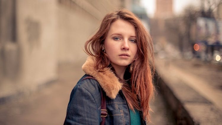 Young Woman Looking Directly At Camera In Jean Jacket 